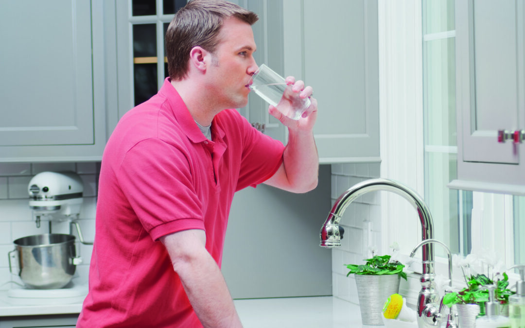 Man Drinking Water in Kitchen