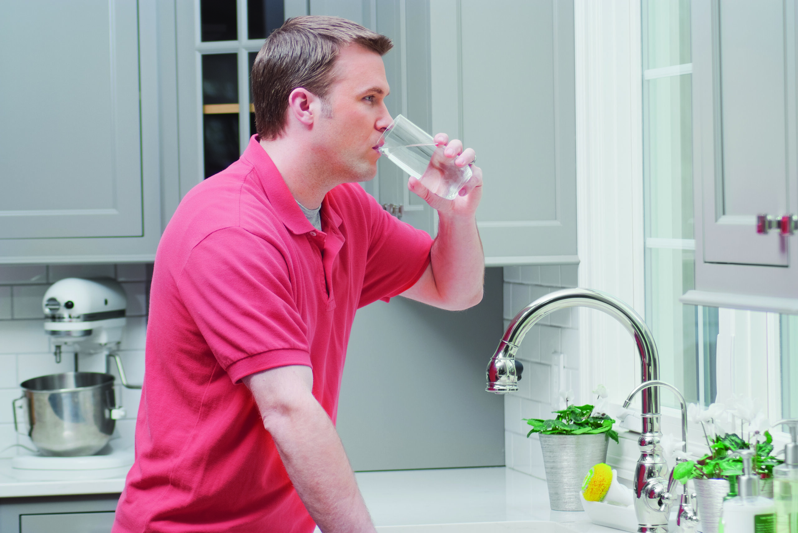 Man Drinking Water in Kitchen